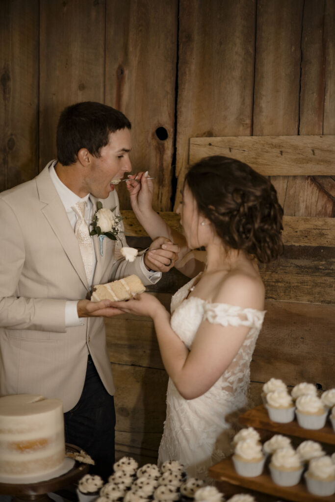 Callie and Matt feed each other wedding cake
