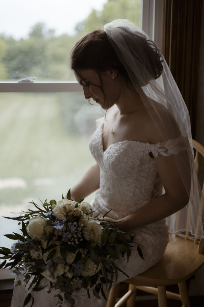 Callie sits by the window admiring her bouquet