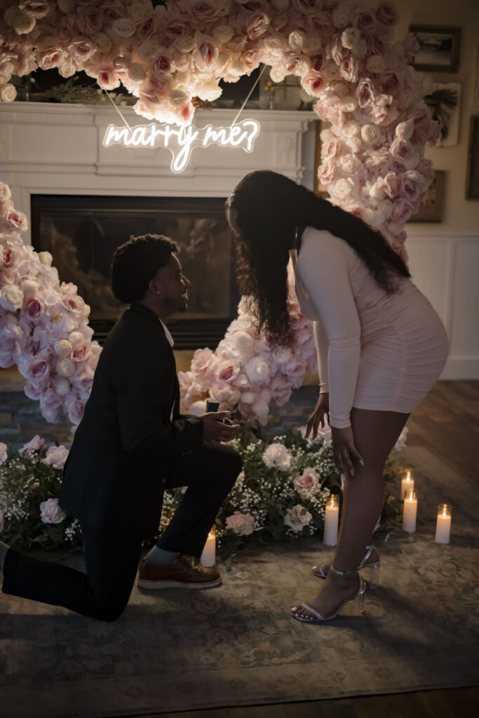 Chris is on his knee asking for Kiki to marry him