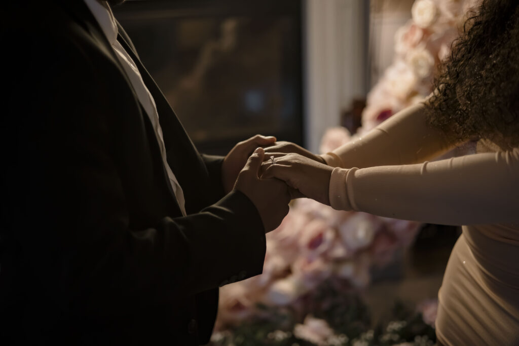 Kiki and Chris hold hands and display her new engagement ring