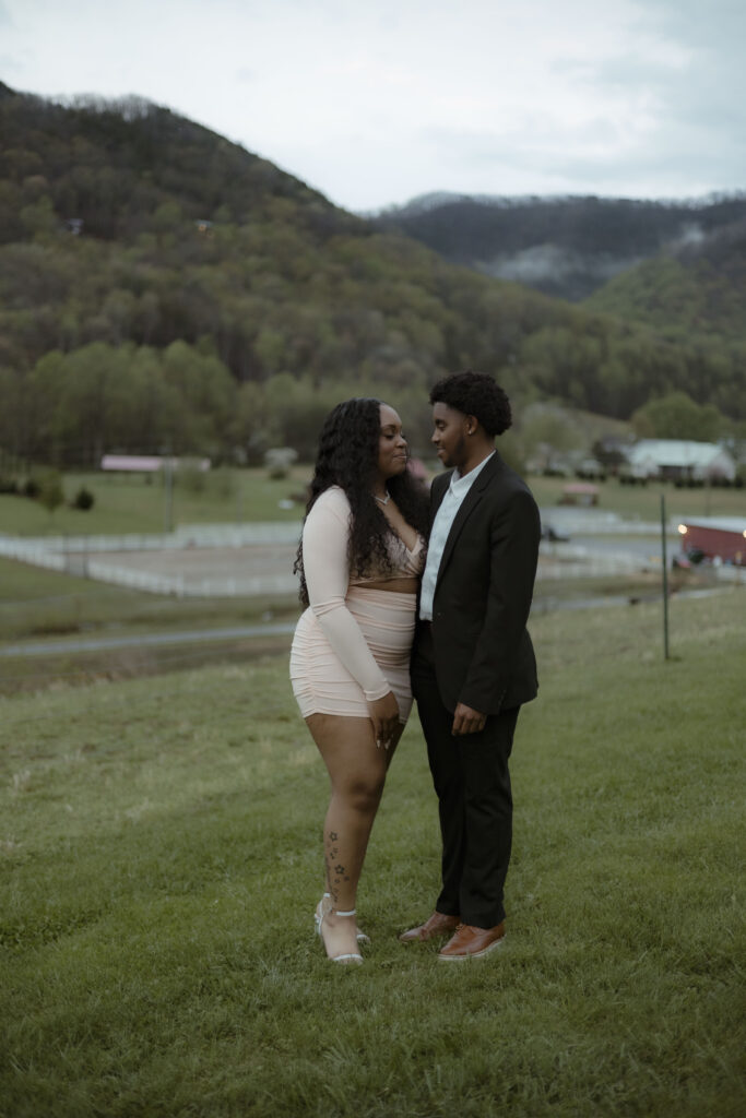 Chris and Kiki stand posed in front of the smoky mountains