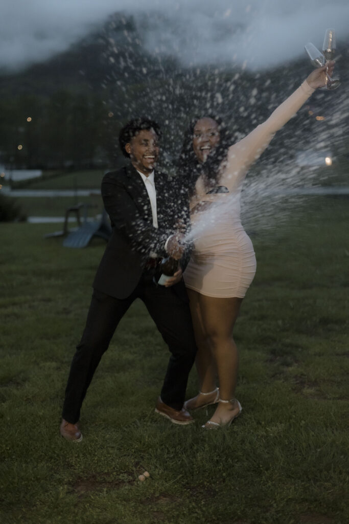 Chris and Kiki pop the champage and cheer 