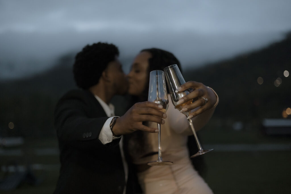 Chris and Kiki toast each other and share a kiss